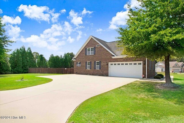 view of front facade with a front yard and a garage