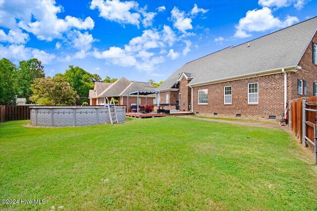 view of yard with a swimming pool side deck