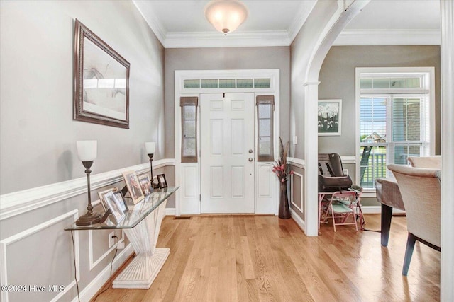 entrance foyer featuring light hardwood / wood-style floors and ornamental molding