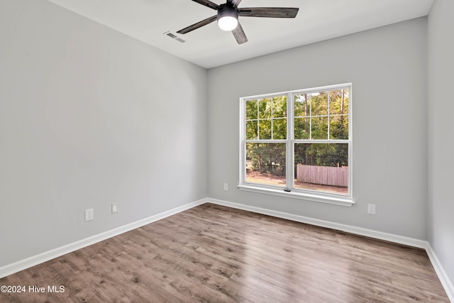 spare room featuring hardwood / wood-style floors and ceiling fan