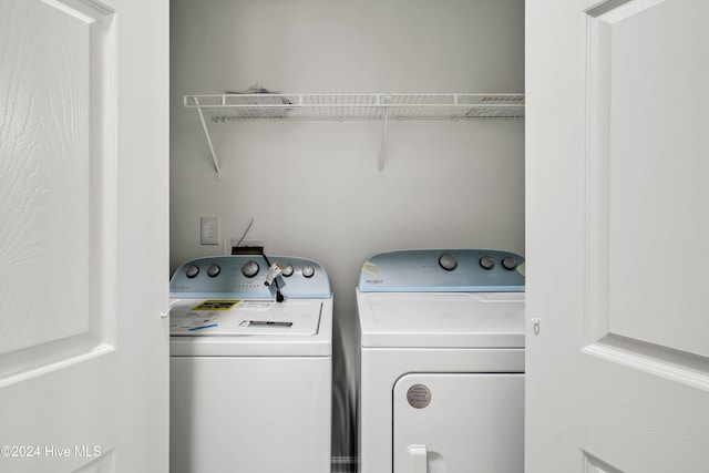 washroom with independent washer and dryer