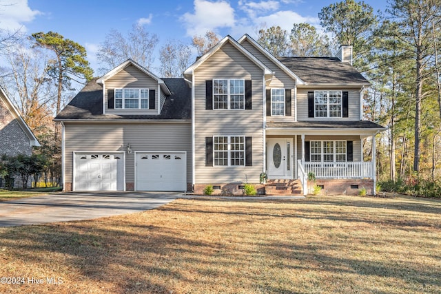 view of front of home featuring covered porch, a garage, and a front yard