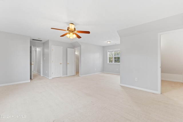 carpeted spare room with ceiling fan