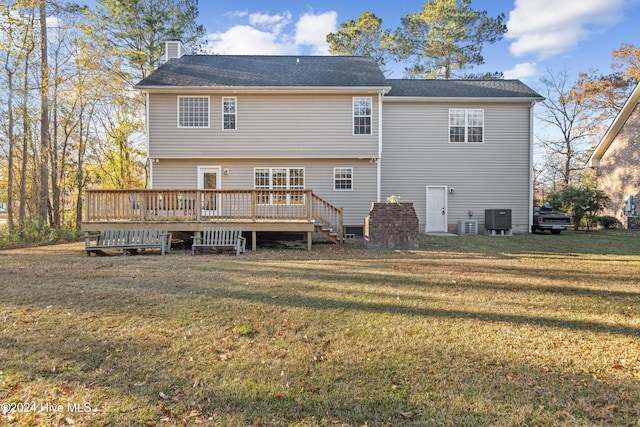 back of house with a lawn, cooling unit, and a wooden deck