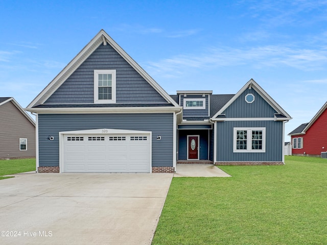 view of front of home featuring a front lawn and a garage