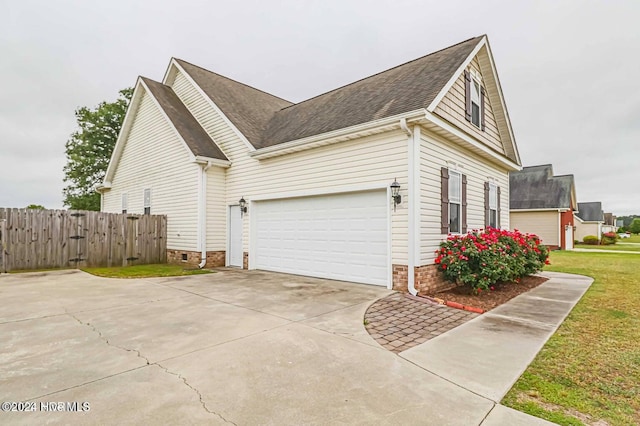 view of property exterior featuring a lawn and a garage