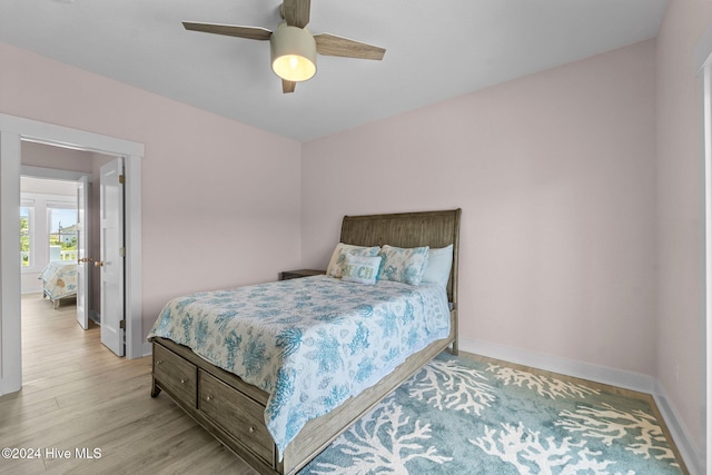 bedroom with light hardwood / wood-style flooring and ceiling fan