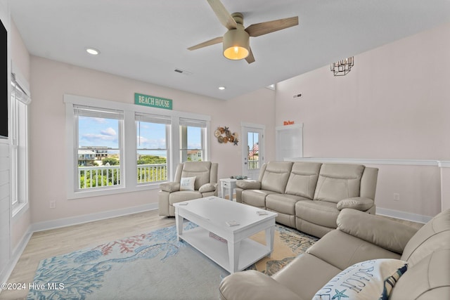 living room with ceiling fan and light hardwood / wood-style floors