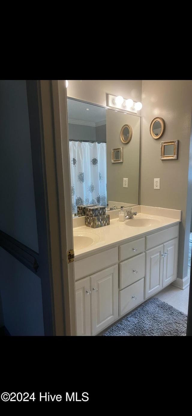 bathroom with crown molding and vanity