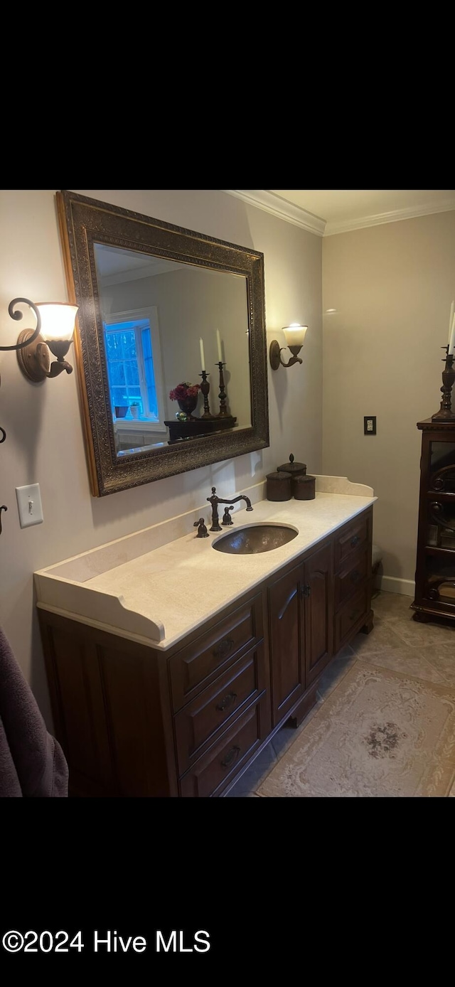 bathroom with vanity and ornamental molding