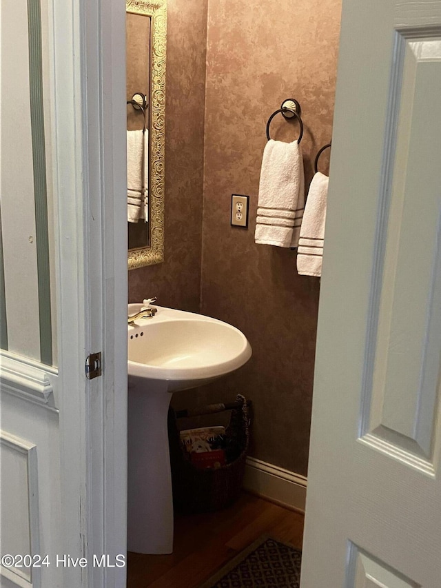 bathroom with wood-type flooring and sink