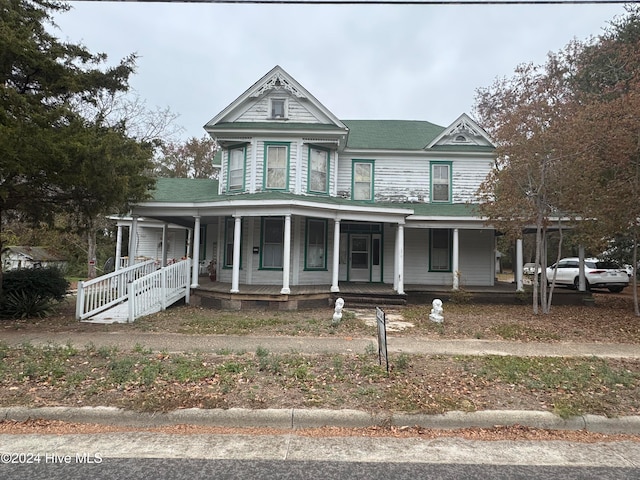 victorian-style house featuring covered porch