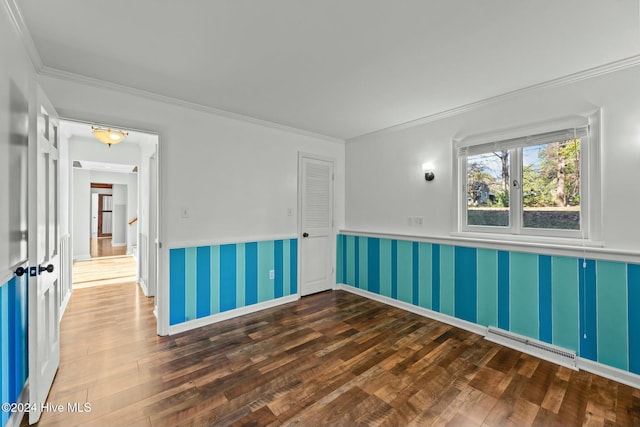 unfurnished room featuring ornamental molding and dark wood-type flooring