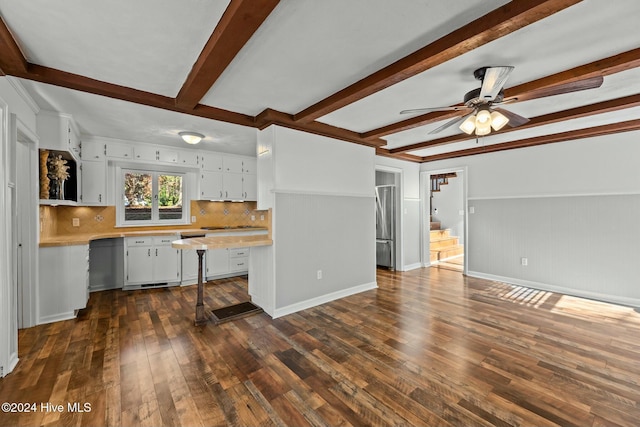 kitchen with decorative backsplash, ceiling fan, dark wood-type flooring, beam ceiling, and white cabinetry