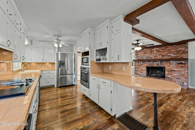 kitchen with white cabinets, dark hardwood / wood-style flooring, sink, and appliances with stainless steel finishes