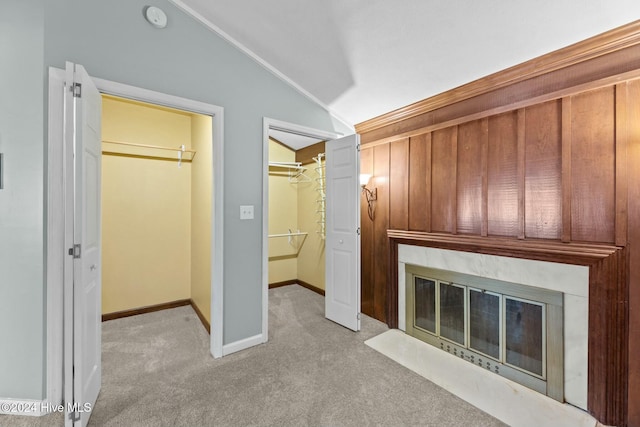 unfurnished living room with light carpet and vaulted ceiling