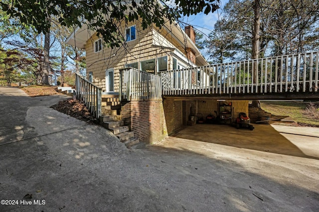 view of property exterior with a wooden deck