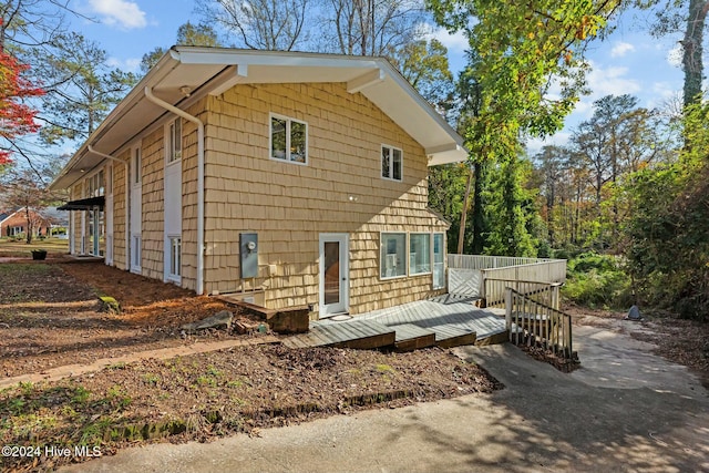 back of house featuring a wooden deck