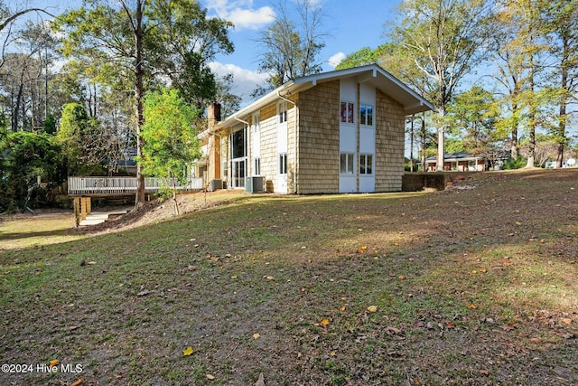 exterior space featuring central AC unit and a wooden deck