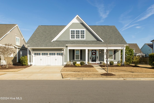 view of front of property with a porch and a garage