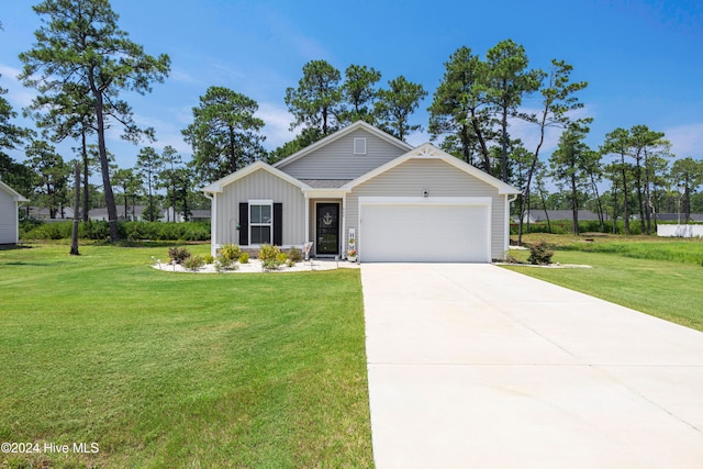 view of front of home with a garage and a front lawn