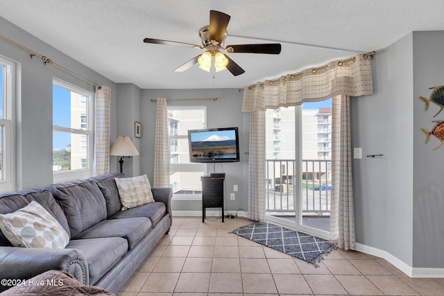 tiled living room with a textured ceiling and ceiling fan