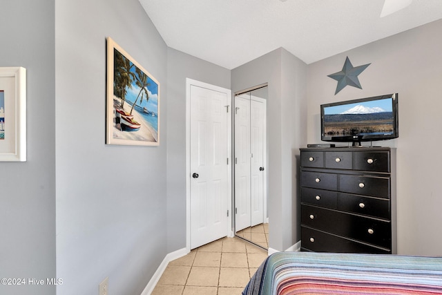 tiled bedroom featuring a closet