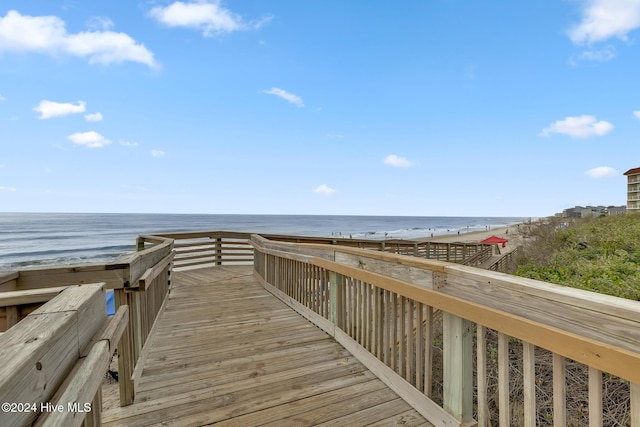 view of property's community with a water view and a view of the beach