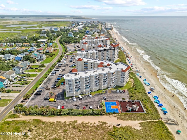 bird's eye view featuring a view of the beach and a water view