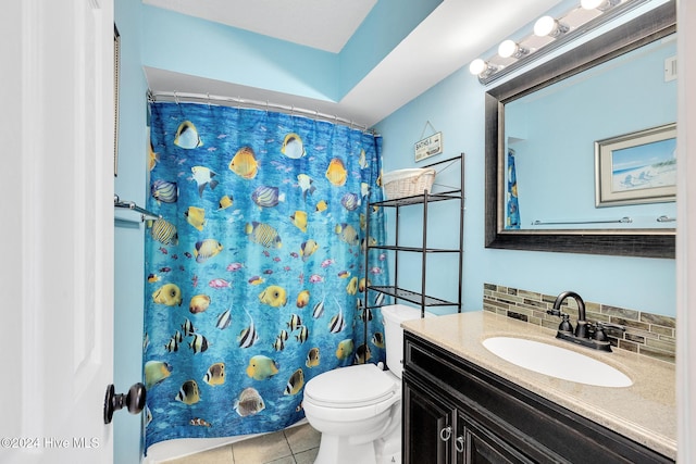 bathroom featuring walk in shower, tasteful backsplash, tile patterned flooring, toilet, and vanity