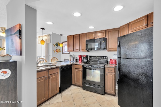 kitchen with light tile patterned floors, sink, hanging light fixtures, and black appliances