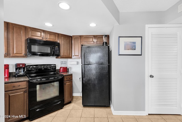 kitchen featuring black appliances and light tile patterned floors