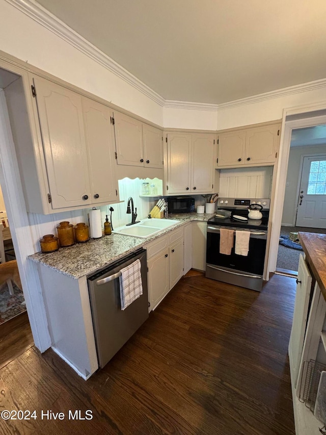 kitchen with ornamental molding, sink, appliances with stainless steel finishes, and dark wood-type flooring