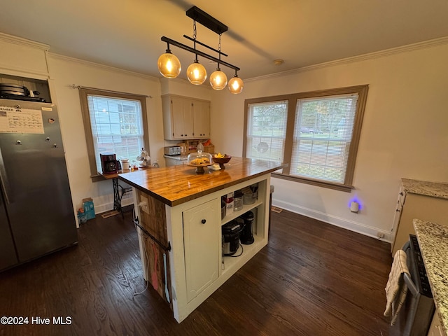 kitchen featuring wood counters, a center island, hanging light fixtures, ornamental molding, and dark hardwood / wood-style flooring