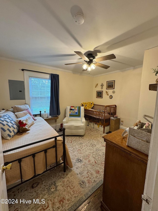 bedroom featuring ceiling fan, dark hardwood / wood-style flooring, ornamental molding, and electric panel