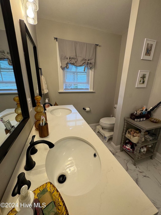 bathroom featuring vanity and toilet