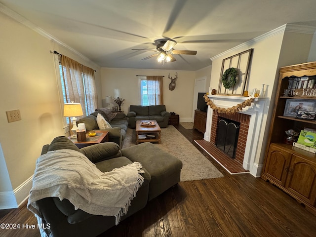 living room with a fireplace, dark hardwood / wood-style floors, ceiling fan, and crown molding