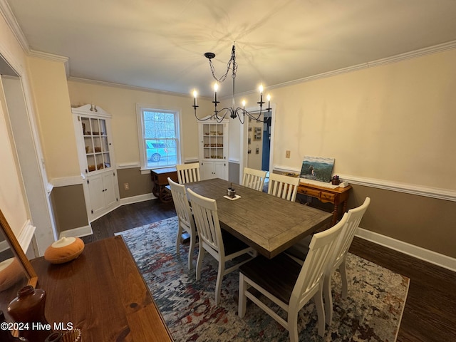 dining area with dark hardwood / wood-style flooring, an inviting chandelier, and crown molding