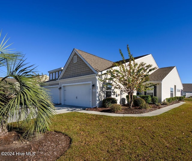 view of front of house with a garage and a front lawn