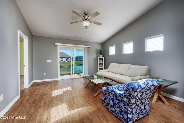 living room featuring ceiling fan, wood-type flooring, and lofted ceiling