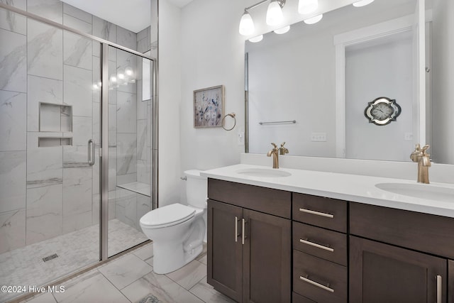 bathroom with vanity, toilet, and a shower with door