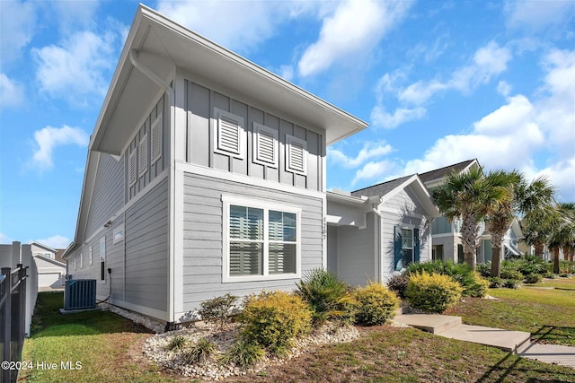 view of property exterior featuring a lawn and central air condition unit