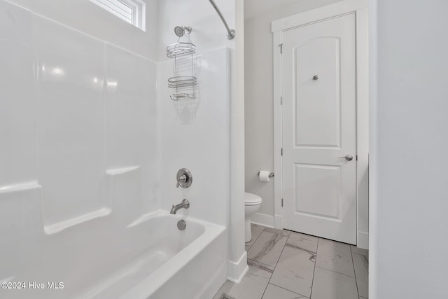 bathroom featuring bathtub / shower combination and toilet