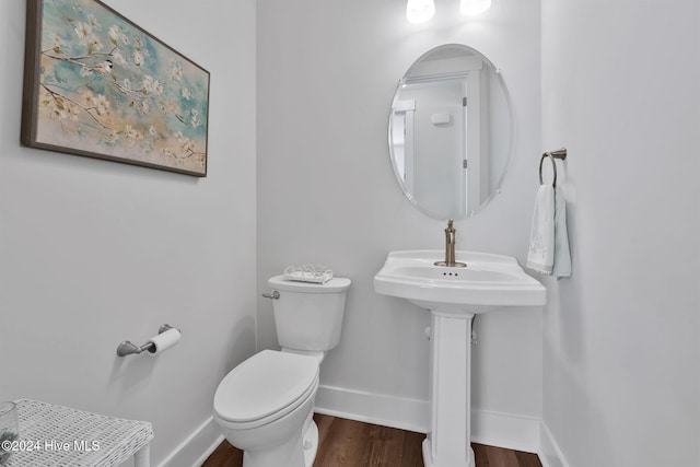 bathroom featuring hardwood / wood-style flooring and toilet