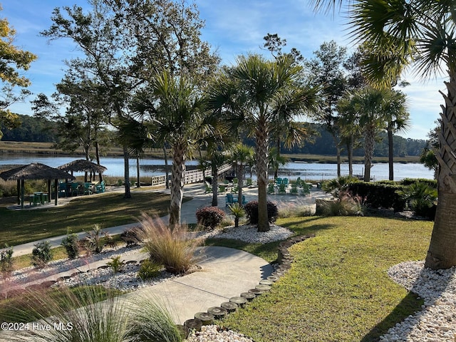 view of home's community featuring a gazebo, a water view, and a lawn