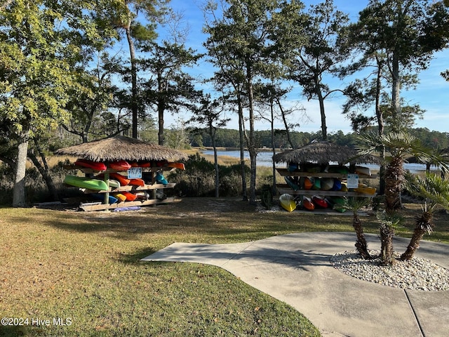 view of front facade with a water view and a front lawn