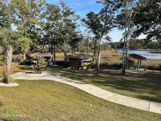 view of home's community with a yard and a water view