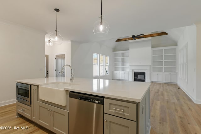 kitchen featuring ceiling fan, built in features, appliances with stainless steel finishes, and gray cabinetry