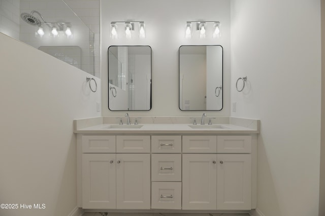 bathroom featuring walk in shower and vanity