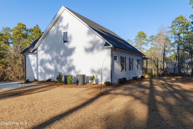 view of side of home with central air condition unit